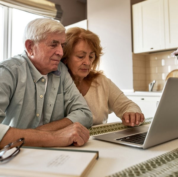 couple in front of a laptop