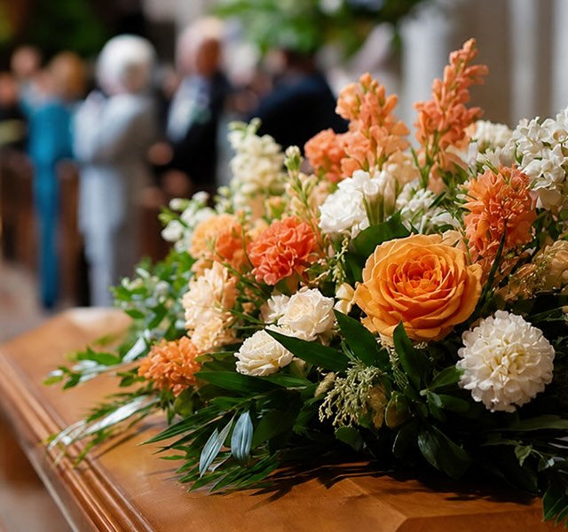 flowers on top of a coffin