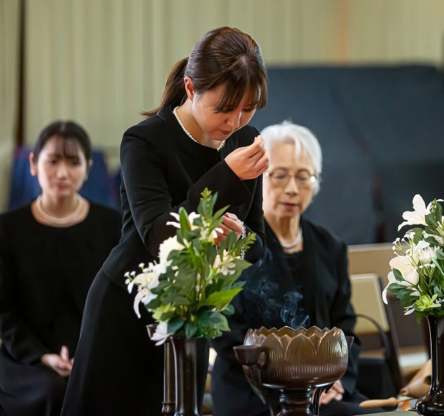 woman paying respect at funeral